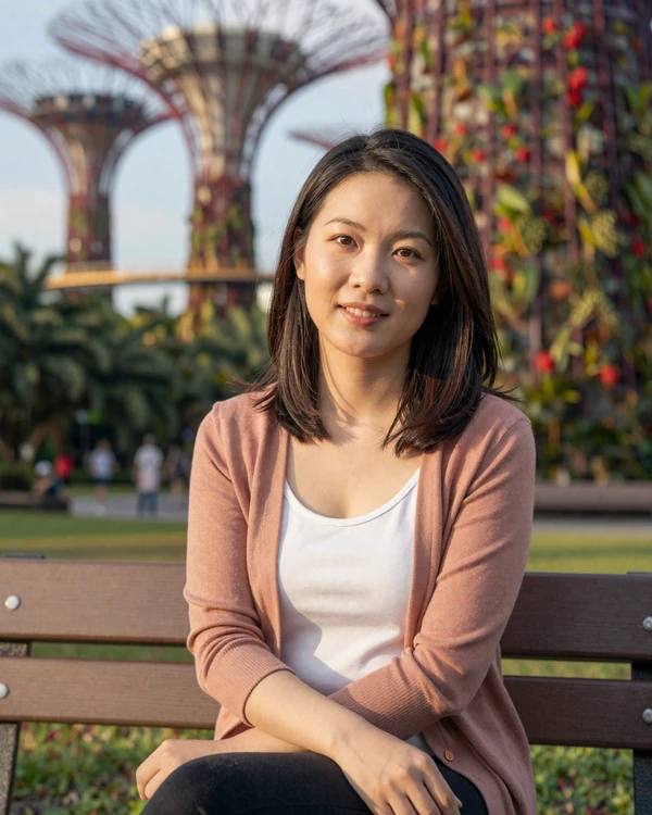 Singaporean woman relaxing in Gardens by the Bay representing modern professional Singapore singles